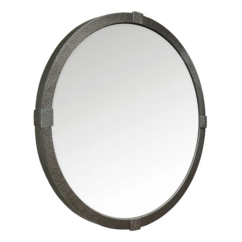 Round mirror with a textured black frame on a white background