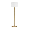 Floor lamp with a white shade and gold base on a white background