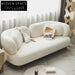 Chic Nordic White Fabric Two-Seater Sofa with Elegant Wooden Frame